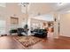 Open-concept living room with a fireplace, hardwood floors, and high ceilings at 765 Rock Ln, Mcdonough, GA 30253