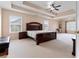 Spacious main bedroom with tray ceiling, carpeted floors, and lots of windows at 765 Rock Ln, Mcdonough, GA 30253