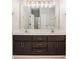 Bathroom featuring a double vanity, and a large mirror with decorative lighting at 1092 Shumard Ln, Mcdonough, GA 30252