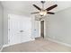 Carpeted bedroom featuring a ceiling fan and double door closet at 1092 Shumard Ln, Mcdonough, GA 30252