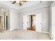 Carpeted bedroom with tray ceiling, and double doors leading to another room at 1092 Shumard Ln, Mcdonough, GA 30252
