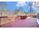 Wooden deck with red paint, perfect for outdoor relaxation at 1092 Shumard Ln, Mcdonough, GA 30252