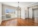 Bright dining room with hardwood floors, chandelier, large window, and elegant trim at 1092 Shumard Ln, Mcdonough, GA 30252