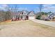 Charming two-story home with brick accents, gray siding and a well-manicured lawn on a sunny day at 1092 Shumard Ln, Mcdonough, GA 30252