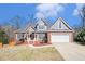Inviting two-story home with brick and gray siding, manicured front yard, and attached two-car garage at 1092 Shumard Ln, Mcdonough, GA 30252