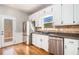 Kitchen with stainless steel appliances, granite countertops, white cabinets, and hardwood floors at 1092 Shumard Ln, Mcdonough, GA 30252