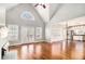 Bright living room with hardwood floors, fireplace, and a view into the kitchen with stainless steel appliances at 1092 Shumard Ln, Mcdonough, GA 30252