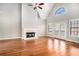 Spacious living room featuring a fireplace and double doors to the deck with beautiful hardwood floors at 1092 Shumard Ln, Mcdonough, GA 30252