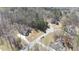 An aerial view displays multiple homes nestled among trees with long driveways in a serene setting at 25 Mountain Crest Dr, Oxford, GA 30054