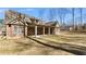 Spacious backyard with a well-maintained lawn and a charming brick home with a covered patio at 25 Mountain Crest Dr, Oxford, GA 30054