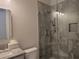 Modern bathroom featuring a glass-enclosed shower with gray tiling and a granite vanity at 25 Mountain Crest Dr, Oxford, GA 30054