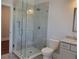 Modern bathroom featuring a glass-enclosed tiled shower, toilet, and granite vanity at 25 Mountain Crest Dr, Oxford, GA 30054