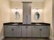 Bathroom vanity with double sinks, granite countertop, decorative mirrors, and ample storage space at 25 Mountain Crest Dr, Oxford, GA 30054