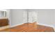 Spacious bedroom with hardwood floors featuring two doors and a bathroom with granite vanity at 25 Mountain Crest Dr, Oxford, GA 30054