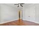 Spacious bedroom featuring hardwood floors, a ceiling fan, double doors, and an en suite bathroom at 25 Mountain Crest Dr, Oxford, GA 30054