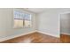 Bright bedroom featuring a window with blinds, hardwood floors, and a walk-in closet at 25 Mountain Crest Dr, Oxford, GA 30054