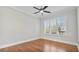 Bedroom with hardwood floors, ceiling fan, and white window shutters at 25 Mountain Crest Dr, Oxford, GA 30054