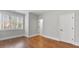 Sunlit bedroom with hardwood floors, features a window and two doors for versatile access at 25 Mountain Crest Dr, Oxford, GA 30054