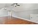 Large bonus room featuring hardwood floors, ceiling fans, and access doors at 25 Mountain Crest Dr, Oxford, GA 30054