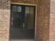 Close-up of the double front door, highlighted by classic brickwork at 25 Mountain Crest Dr, Oxford, GA 30054