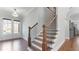 Charming staircase is highlighted with a wrought iron railing, complemented by new hardwood floors at 25 Mountain Crest Dr, Oxford, GA 30054