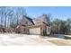 Charming two-story brick home featuring an attached garage and manicured lawn at 25 Mountain Crest Dr, Oxford, GA 30054