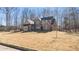 Well-maintained two-story brick home with a manicured front yard and mature trees at 25 Mountain Crest Dr, Oxford, GA 30054