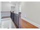 Hallway on second floor, with wood floors and railings overlooking the staircase at 25 Mountain Crest Dr, Oxford, GA 30054