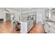Kitchen island with bar seating, stainless steel appliances, and a view of the living room at 25 Mountain Crest Dr, Oxford, GA 30054