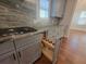 Kitchen featuring a cooktop, granite countertops, and pull out shelves at 25 Mountain Crest Dr, Oxford, GA 30054