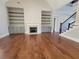 Inviting living room featuring a fireplace, built-in shelving, and hardwood floors at 25 Mountain Crest Dr, Oxford, GA 30054