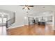 Open-concept living room with hardwood floors, a staircase, and a view into the kitchen at 25 Mountain Crest Dr, Oxford, GA 30054