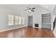 Bright living room with hardwood floors, built-in shelving, and a cozy fireplace at 25 Mountain Crest Dr, Oxford, GA 30054