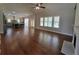 Spacious living room featuring hardwood floors, a ceiling fan, and bright windows at 25 Mountain Crest Dr, Oxford, GA 30054