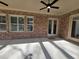 Covered brick patio with ceiling fans and ample space for outdoor seating, perfect for relaxation at 25 Mountain Crest Dr, Oxford, GA 30054