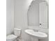 Stylish powder room with pedestal sink, decorative mirror, and modern fixtures for guests' convenience at 25 Mountain Crest Dr, Oxford, GA 30054