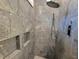 Modern shower featuring gray marble-like tiles, rainfall showerhead and convenient built-in shelving niches at 25 Mountain Crest Dr, Oxford, GA 30054