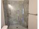 Modern bathroom shower featuring marble tiling, a glass door, and built-in niche at 25 Mountain Crest Dr, Oxford, GA 30054