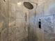 A spacious shower showcasing gray marble-like tiling, dual shower heads, and digital control panel at 25 Mountain Crest Dr, Oxford, GA 30054