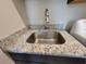 Close-up of laundry sink with stainless steel fixtures and granite countertops at 25 Mountain Crest Dr, Oxford, GA 30054