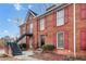 Exterior view of two-story brick home with red shutters and a black stairway leading to an upper unit at 1166 Booth Sw Rd # 605, Marietta, GA 30008