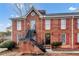 Brick two story home with red shutters and black stairs leading to the second floor unit at 1166 Booth Sw Rd # 605, Marietta, GA 30008