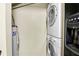 Laundry room features stacked washer and dryer with water heater at 1166 Booth Sw Rd # 605, Marietta, GA 30008