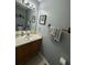 Updated bathroom featuring a vanity, framed art, and stylish fixtures offering a cozy and functional space at 2469 Briar Knoll Rd, Lithonia, GA 30058