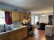 Updated kitchen with stainless steel appliances, oak cabinets, and a view to the dining area at 2469 Briar Knoll Rd, Lithonia, GA 30058