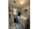 Well-lit laundry room with modern washer and dryer, shelving and ample storage space at 2469 Briar Knoll Rd, Lithonia, GA 30058