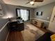 Dedicated office space boasts hardwood floors, calming paint color, desk, TV and storage console at 2469 Briar Knoll Rd, Lithonia, GA 30058