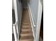 Carpeted staircase with white railing leads to the upper level of the home at 2469 Briar Knoll Rd, Lithonia, GA 30058
