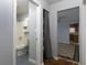 Bathroom with vintage blue tile floors, tub/shower, and built-in cabinet at 3844 Oglesby Rd, Powder Springs, GA 30127