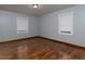 Comfortable bedroom with hardwood flooring, neutral paint, and double windows at 3844 Oglesby Rd, Powder Springs, GA 30127